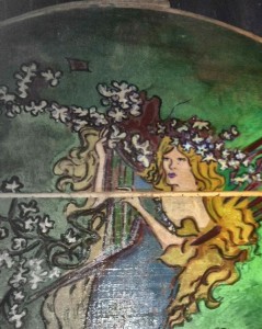 This is a close-up of detail painted on the circular lid of a wooden crate. It hangs above my dryer in the basement. I was in my 30s when I found the crate in Vermont.